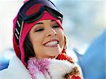 Portrait of a happy young girl snowboarding