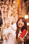 Japanese Women Holding Christmas Gift And Waving