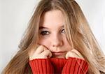 Portrait of a sad expression young woman with red pullover