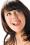portrait of a cute brunette licking her lips and making face
