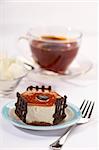 coffee fancy cake with chocolate and tea on background