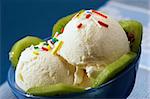 close up vanilla ice-cream with multicolored knick-knackery over blue