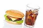 Cheeseburger and soda glass, reflected on white background. Shallow DOF