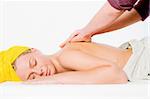 Studio portrait of a spa girl getting a shoulder massage