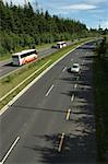 Very Long Empty two lane Motorway with Busy Traffic travelling through the country