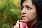 woman and apple in autumn park