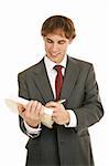 Handsome young businessman reviewing a good report.  Isolated on white.