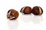 Three cooked chestnuts with reflection, isolated