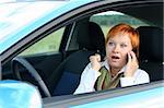 Red-haired woman with mobile-phone in a car. She is amazing