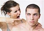 Couple in angry dispute; woman is pointing accusatory finger at man