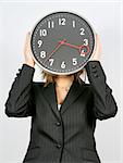 young businesswoman with clock covering her head