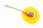 Honey and wooden drizzler with soft shadow on white background. Shallow DOF