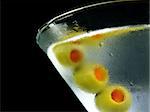 martini with olives isolated on black