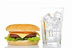 Cheeseburger and empty glass with ice cubes, reflected on white background. Shallow DOF