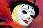 Clown in white mask, and top hat - close up