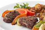 kebab served with grilled vegetables on white plate, selective focus