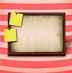 wooden frame and to yellow notes against striped background