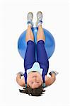 Woman lying down with a gym ball- interesting and unusual perspective.