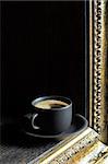 Black coffee in a cup on a background of a beautiful frame