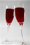 Two glasses with red wine in contact