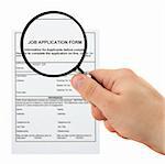 concept of searching for personnel - hand with magnifying glass and job application form
