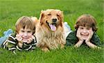Two Boys and a Dog With Big Smiles