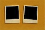 two old photo frames against rough paper