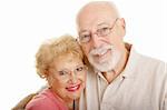 Senior couple wearing glasses.  White background.