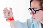 Scientist woman analyzing chemical material in Erlenmeyer flask