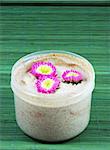 Spa and beauty products - body scrub and flowers.