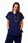 Pretty young woman healthcare worker wearing blue scrubs and a stethoscope standing on white with hands in pocket
