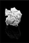 crumpled paper ball with it's reflection on deep black background