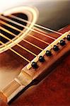 Acoustic guitar bridge and strings close up