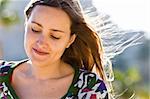 Woman smiling with hair flying on the wind.