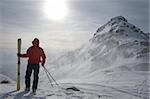 A lone skier on a high mountain pass during a snow storm