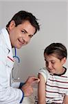 A child receives an immunisation or vaccination shot from a friendly doctor or healthcare worker.