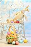 Easter bunny with eggs on garden chair