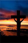 A cross at sundown on the ocean