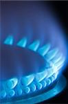 Blue flames of a gas stove in the dark