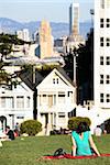 People relaxing on oa sunny day in Alamo park in San Francisco