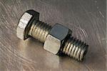 bolt and nut on metallic background