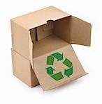 close-up of cardboard boxes with recyclable symbol against white background