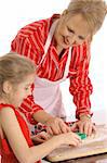 beautiful woman and child decorating cookies