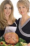 mother and daughter cooking ham together