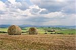 Hay bales on rural landscape. Tuscany, Italy