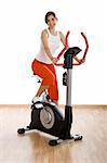Young woman training on exercise bike at the gym