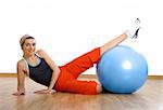 Beautiful young woman making exercises with a core ball