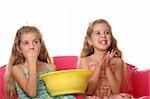 children watching a movie laughing & eating popcorn