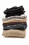 Stack of various garments. White background.