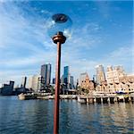 Lamppost in  Sydney Cove with city skyline and water in Sydney, Australia.